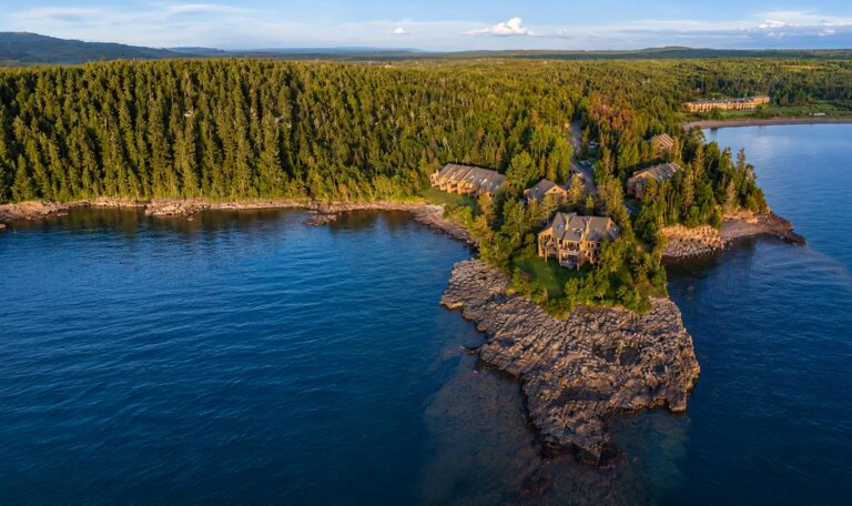 Aerial view of the rocky point and forest surrounding Superior Shores Resort