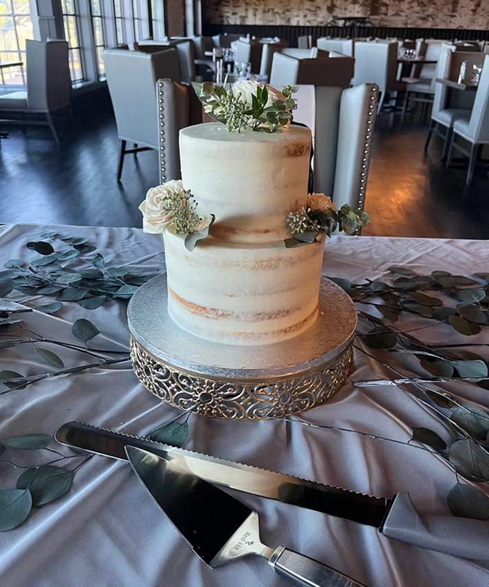 Wedding cake and serving set on a draped table at Superior Shores Resort