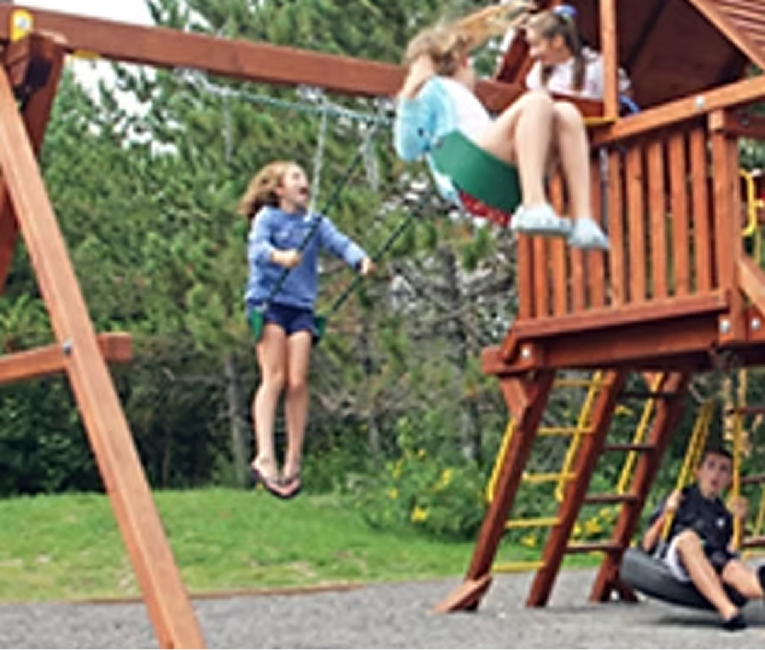 Children playing on the outdoor playground at Superior Shores Resort