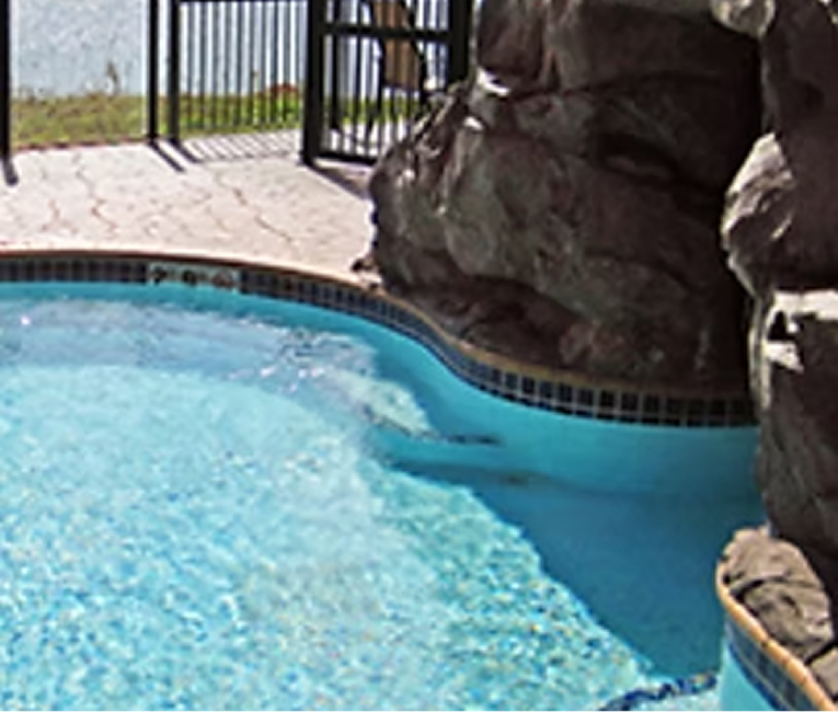 Indoor pool with rock waterfall feature at Superior Shores Resort