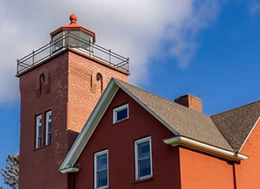 Two Harbors Lighthouse tower against a blue sky