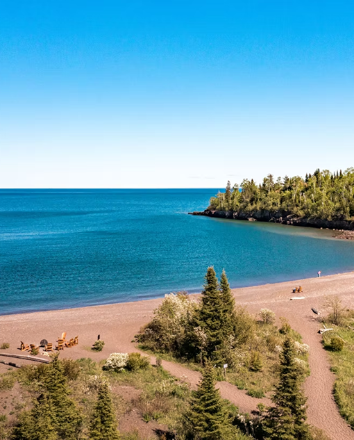 Sand beach and turquoise water of Lake Superior at Superior Shores Resort