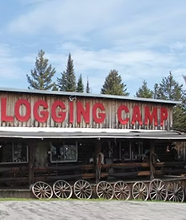 Rustic Logging Camp attraction building with wagon wheels out front