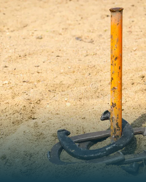 Horseshoe pit stake in the sand at the resort lawn games area