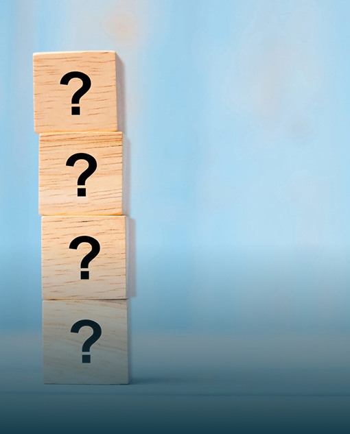 Wooden blocks with question marks representing frequently asked questions